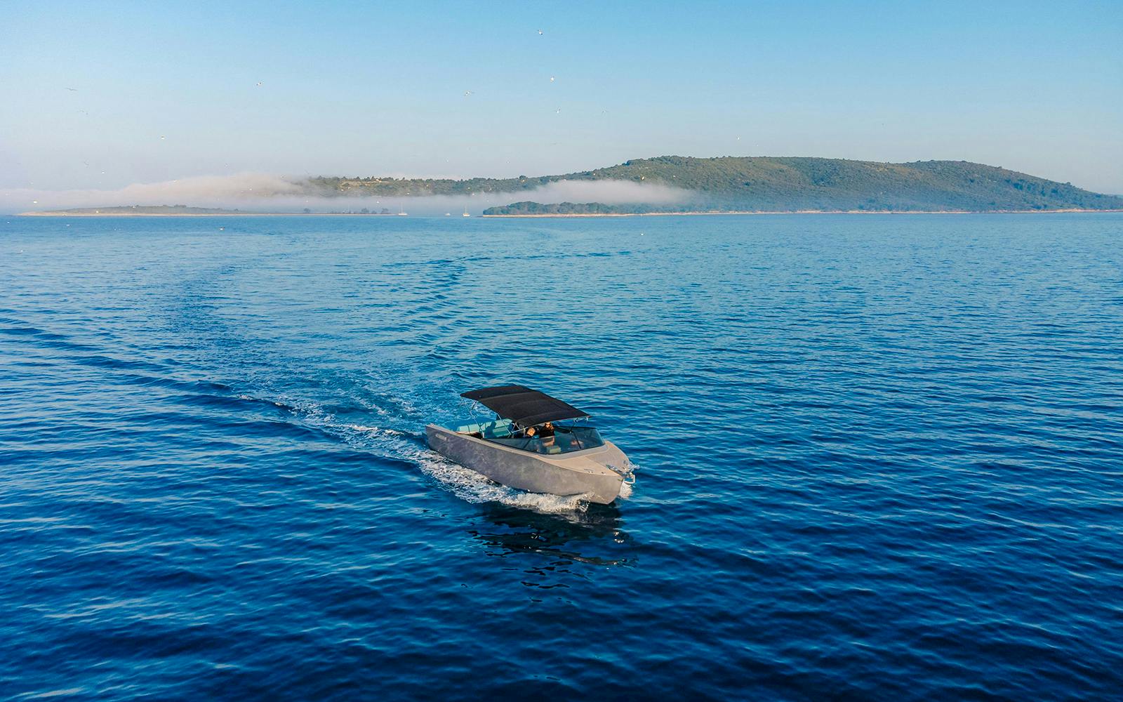 Luxury boat cruising on Blue Lagoon tour with distant island view.