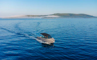 Luxury boat cruising on Blue Lagoon tour with distant island view.