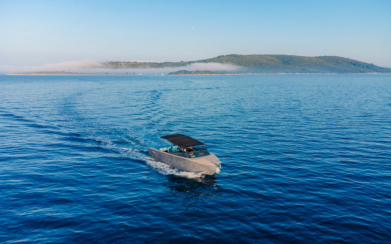 Luxury boat cruising on Blue Lagoon tour with distant island view.