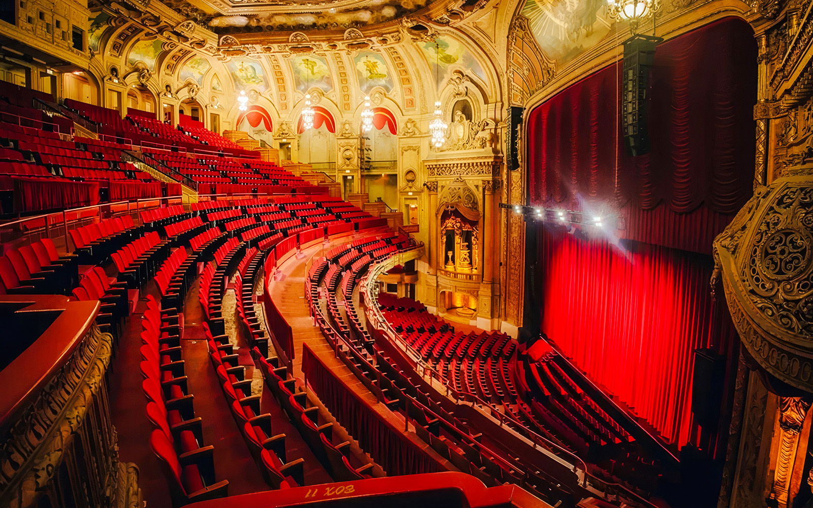 Interior of The Chicago Theatre with ornate architecture and red seating.