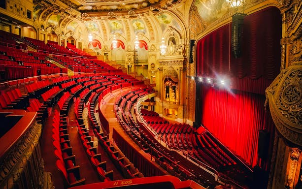 Interior of The Chicago Theatre with ornate architecture and red seating.