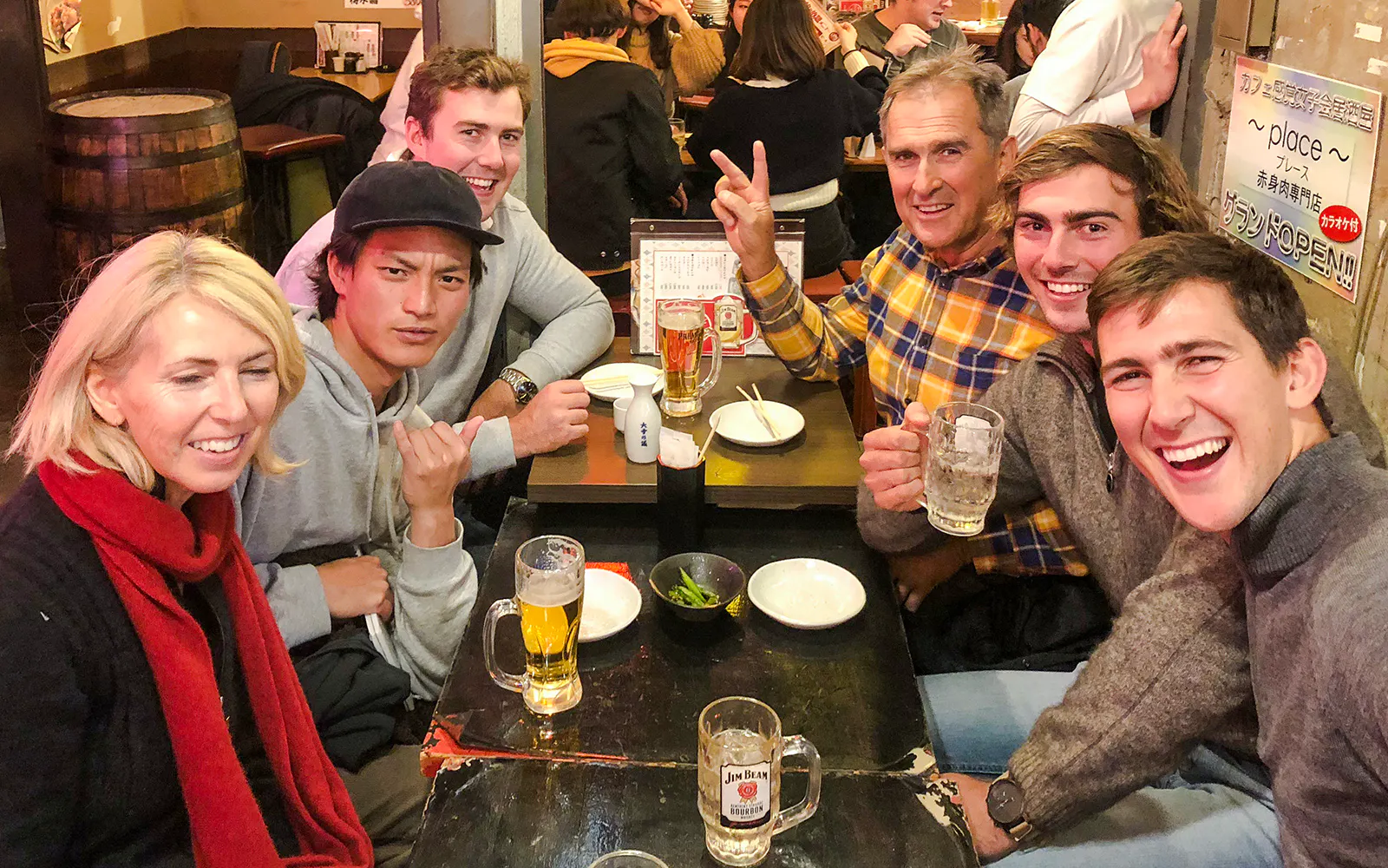 Group enjoying drinks at a local izakaya bar with authentic Japanese cuisine.