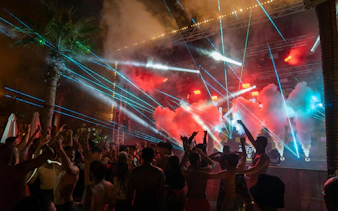 Crowd enjoying laser show and music at Aquaventure After Dark party.