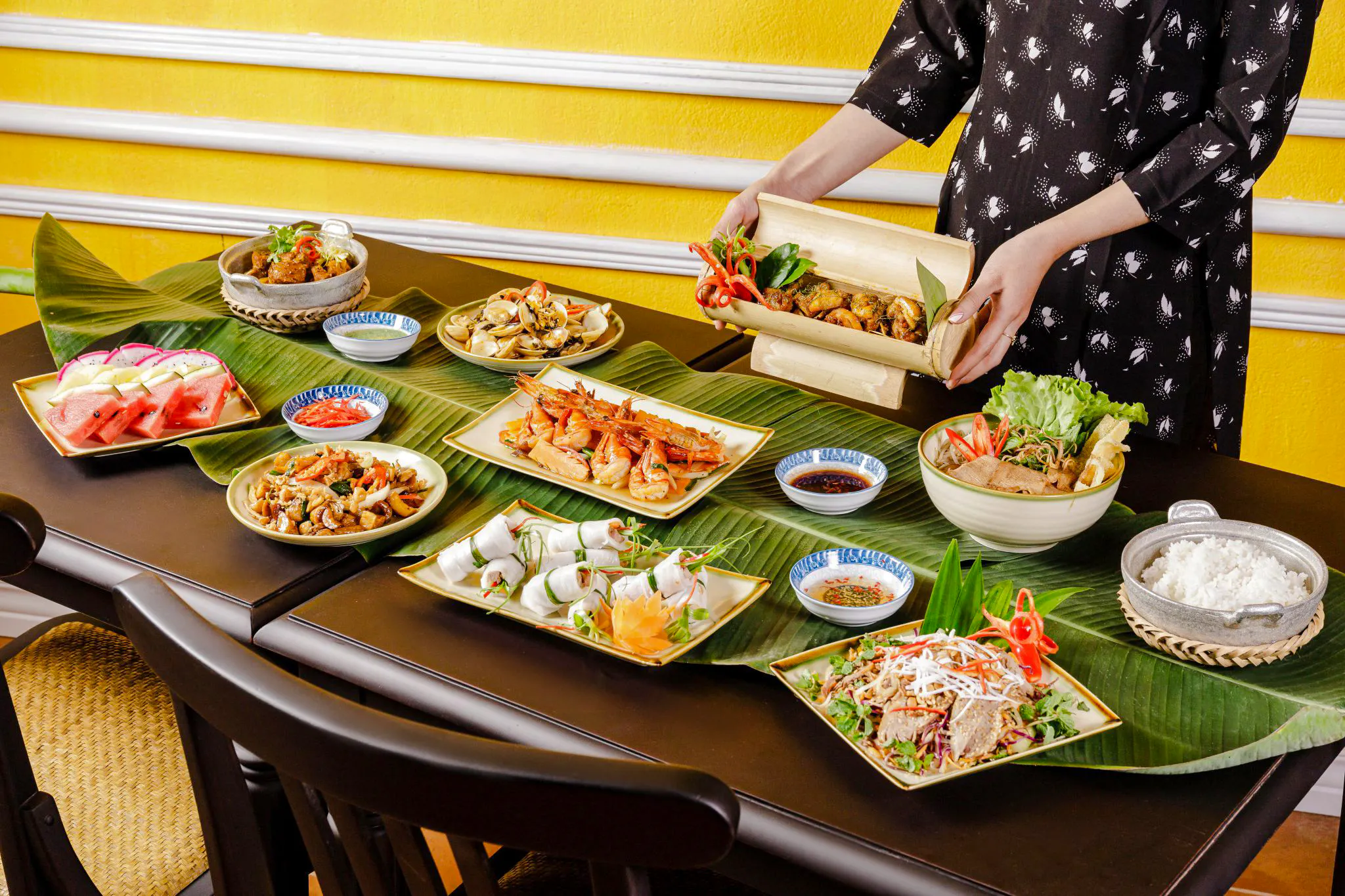 All-you-can-eat Vietnamese dishes at HOME Hoi An Restaurant, featuring seafood and fresh vegetables.