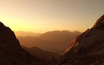 Sunrise view from Mount Sinai during guided ascent on St. Catherine Monastery tour, Egypt.
