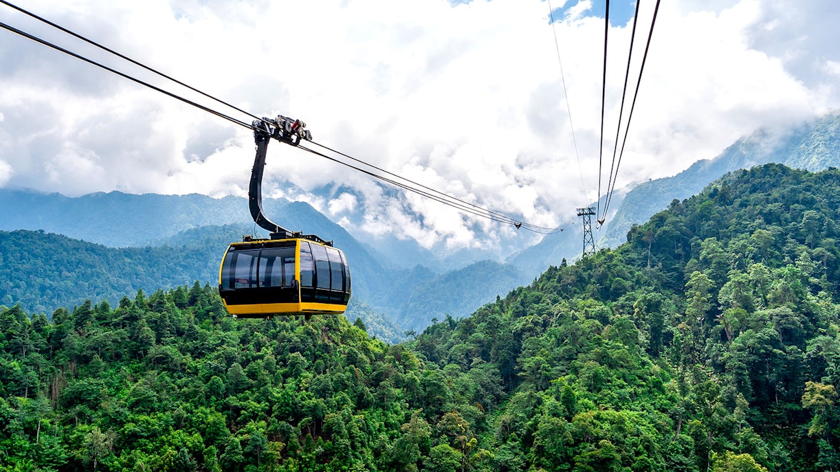 Cable car over lush green mountains at Sun World Fansipan, Vietnam.