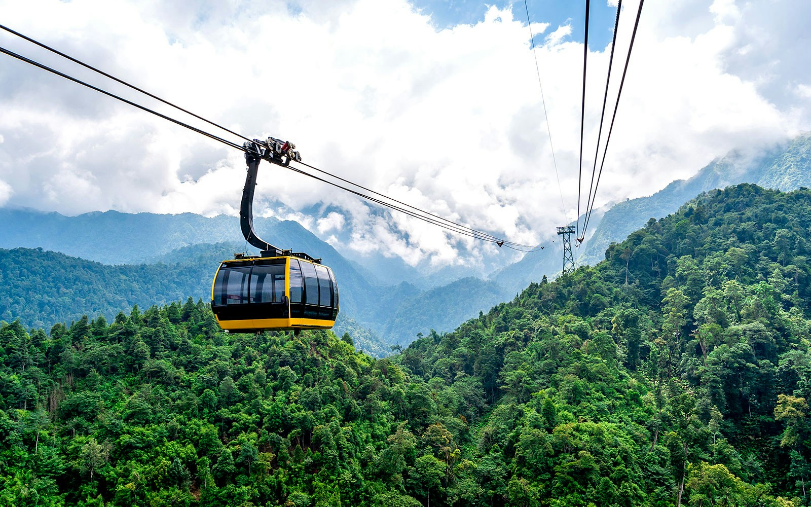 Cable car over lush green mountains at Sun World Fansipan, Vietnam.