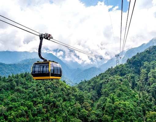 Cable car over lush green mountains at Sun World Fansipan, Vietnam.