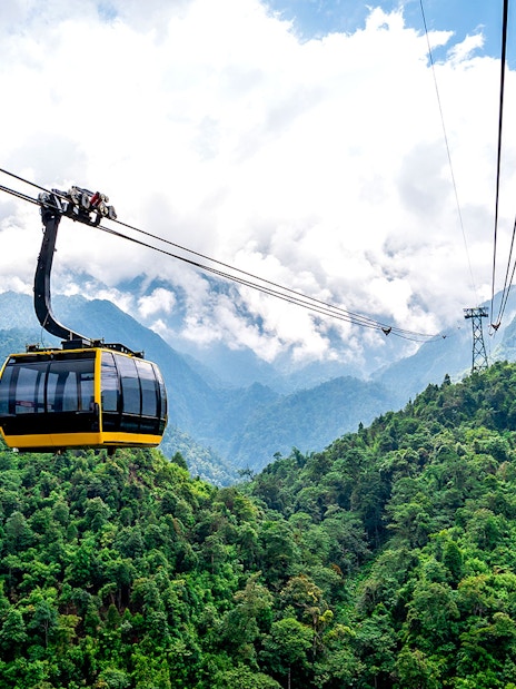 Cable car over lush green mountains at Sun World Fansipan, Vietnam.