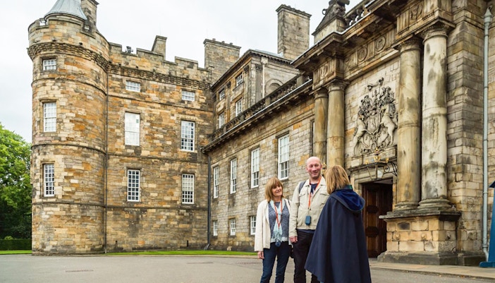 Visitors at Royal Edinburgh Tour with skip-the-line access to three royal attractions and hop-on hop-off bus.