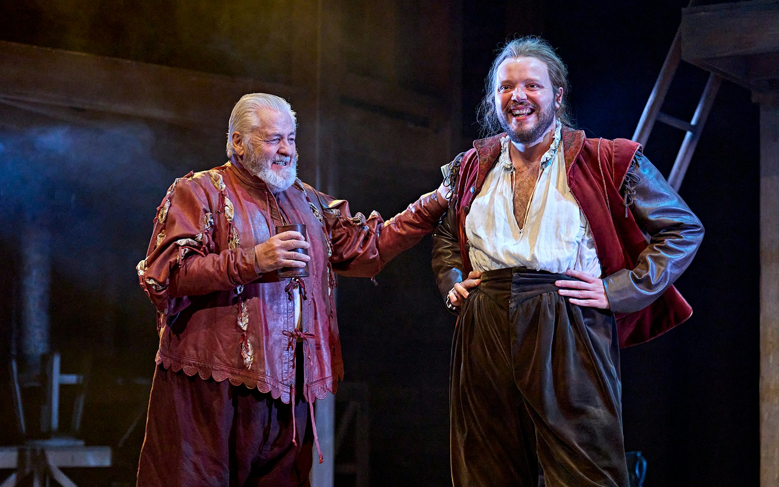 Actors in period costumes performing a scene from "Hamnet" on stage.