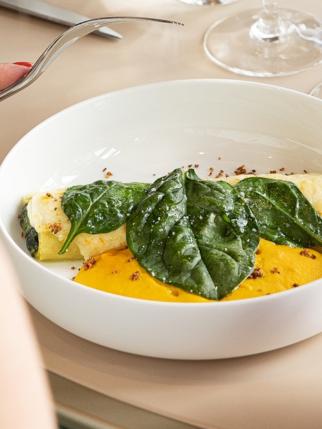 Lunch dish with spinach and sauce at Eiffel Tower's Madame Brasserie, Paris.