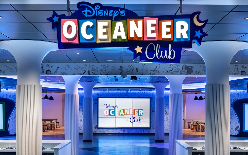 Disney Oceaneer Club entrance on Disney Cruise Line with colorful signage and themed decor.