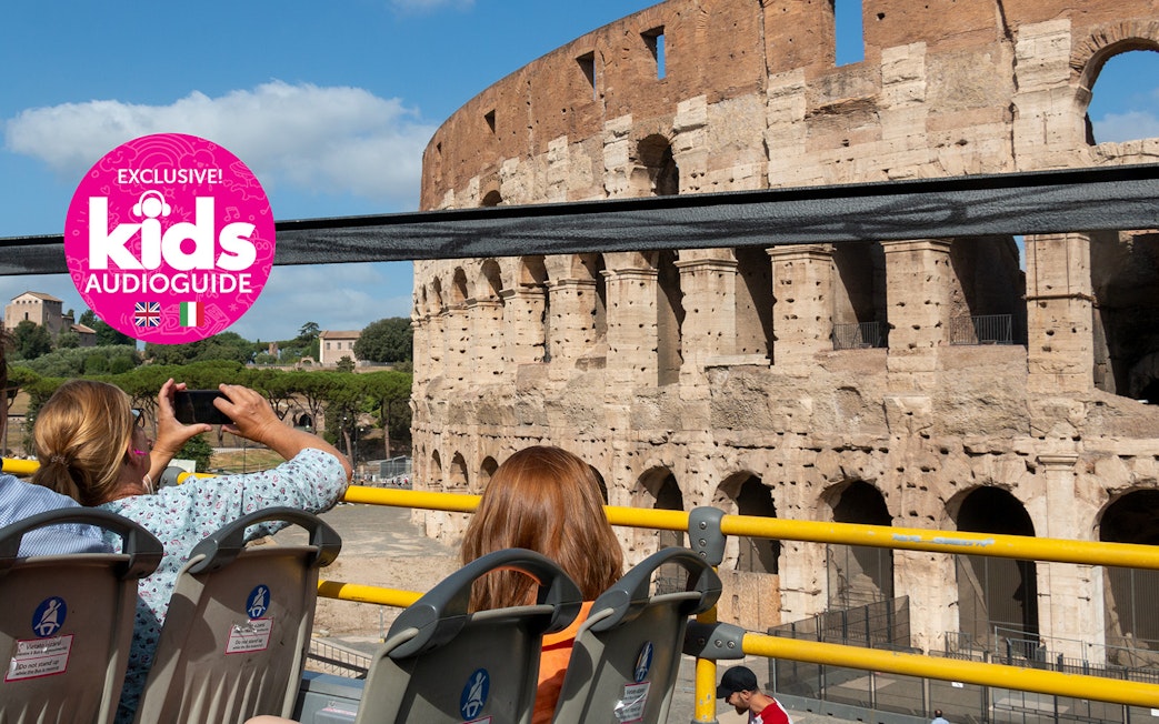 Hop-on hop-off bus near Colosseum in Rome with kids' audio guide.