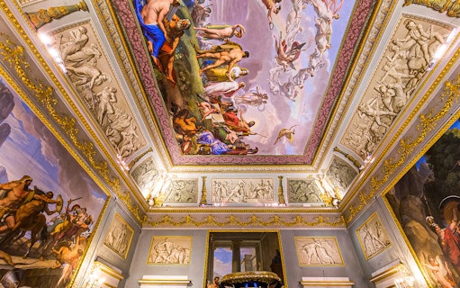Ceiling frescoes and ornate decorations inside Pitti Palace, Florence, Italy.