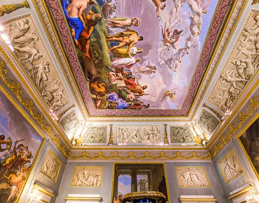 Ceiling frescoes and ornate decorations inside Pitti Palace, Florence, Italy.
