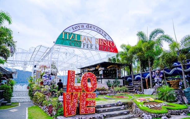Italian restaurant Toya Coffee & Bar entrance at Toya Devasya with garden and LOVE sign.