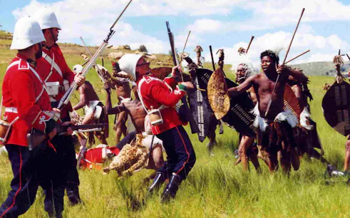 British soldiers and Zulu warriors reenactment in a field during Durban tour adventure.