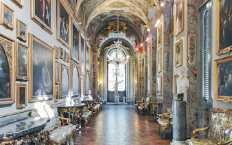 Doria Pamphilj Gallery interior with classic paintings and ornate decor in Rome, Italy.