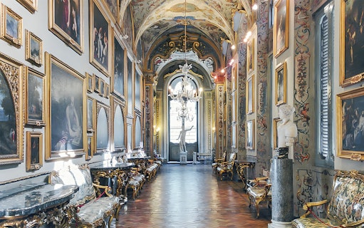 Doria Pamphilj Gallery interior with classic paintings and ornate decor in Rome, Italy.