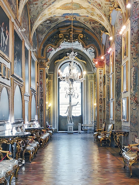 Doria Pamphilj Gallery interior with classic paintings and ornate decor in Rome, Italy.