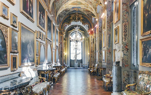 Doria Pamphilj Gallery interior with classic paintings and ornate decor in Rome, Italy.