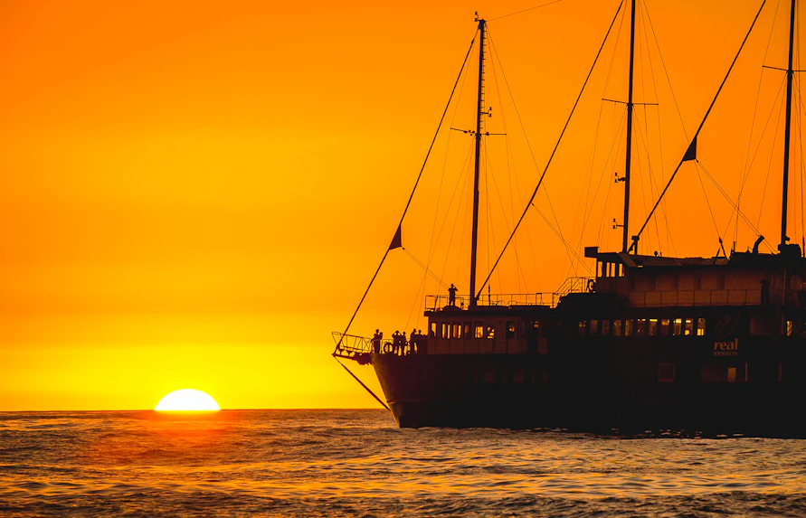 Cruise ship at sunset on Milford Sound overnight tour.
