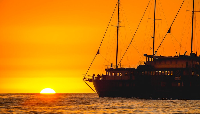 Cruise ship at sunset on Milford Sound overnight tour.