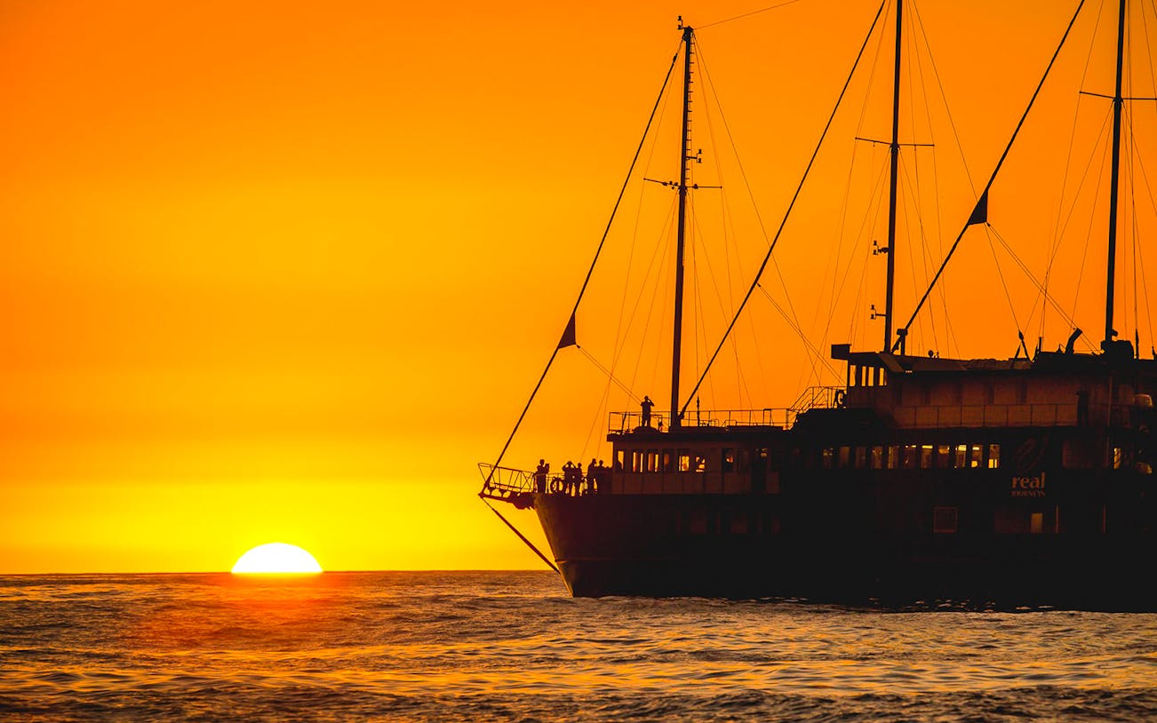 Cruise ship at sunset on Milford Sound overnight tour.
