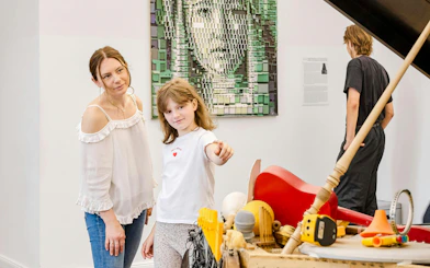 Visitors exploring interactive exhibits at IAM Illusion Art Museum, Prague.