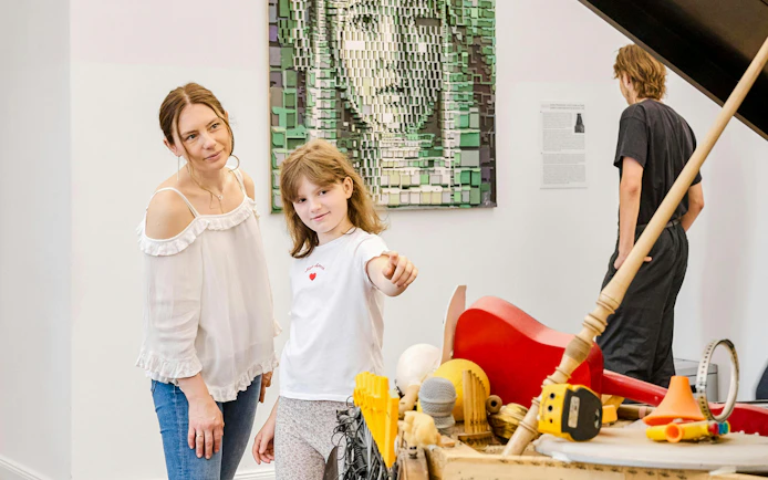 Visitors exploring interactive exhibits at IAM Illusion Art Museum, Prague.