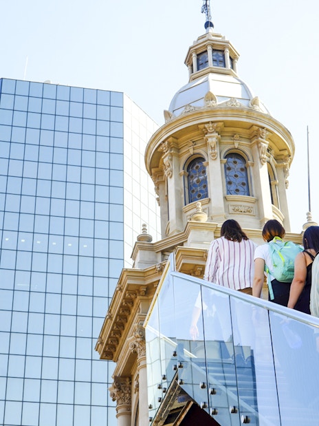 Guests ascending stairs with guide at Santiago Cathedral Bell Tower.
