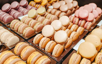 Assorted macarons displayed on trays during the Ultimate Paris Food Tour.