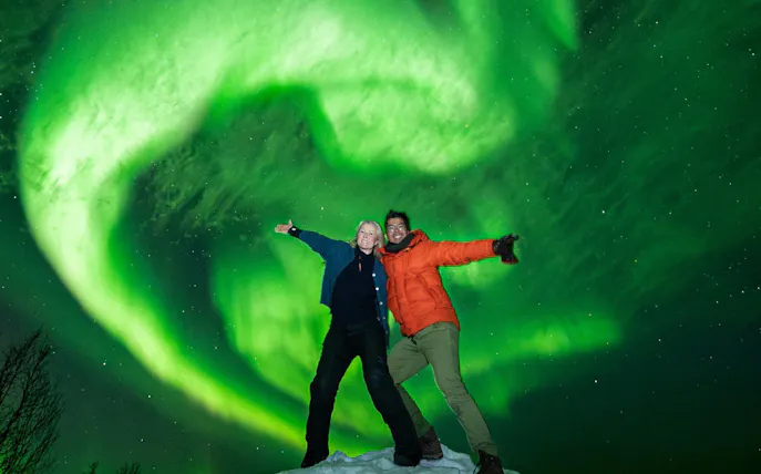 People enjoying the Northern Lights in Tromso on a small group tour.