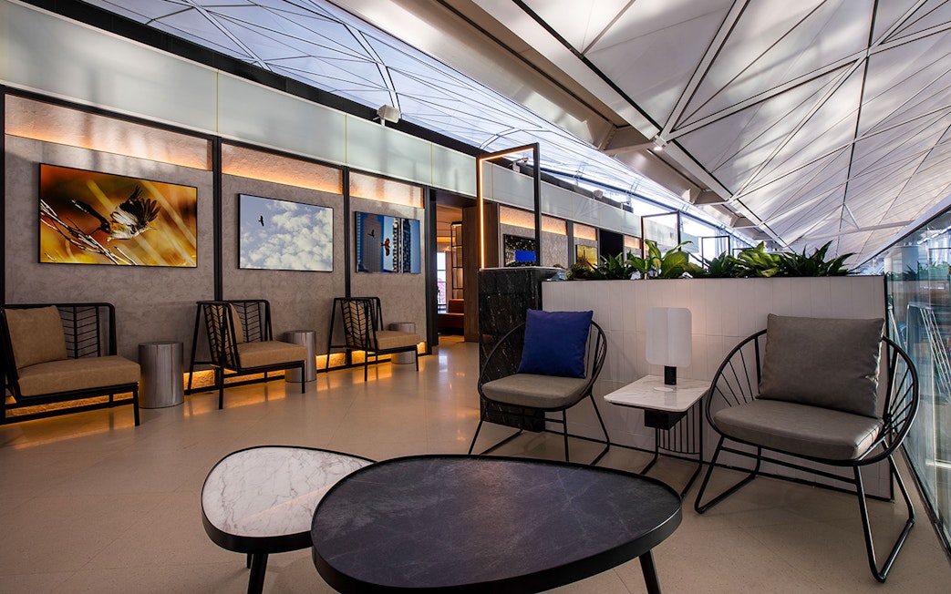 Plaza Premium Lounge seating area with modern decor and wall art.