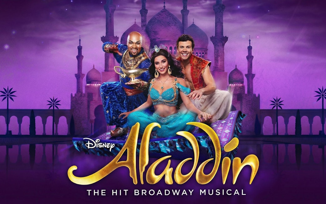 Aladdin Broadway musical characters on a magic carpet with a palace backdrop.