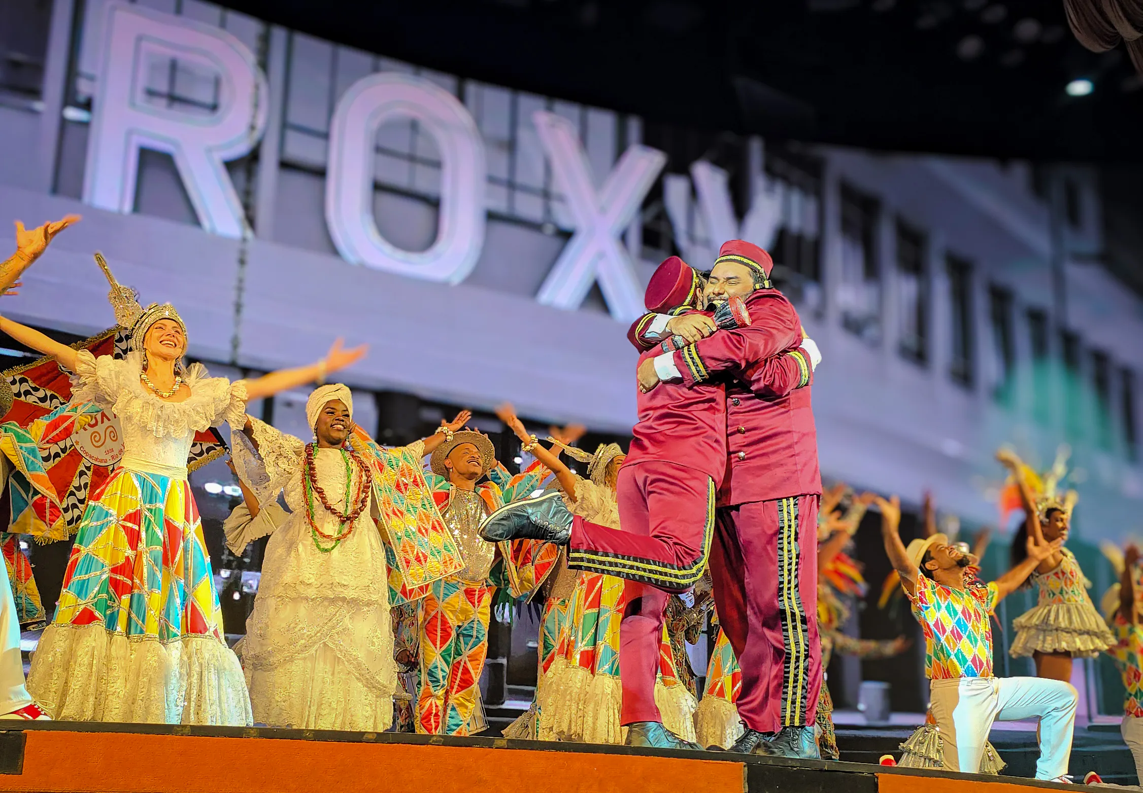 Performers in vibrant costumes on stage at Roxy Dinner Show, Rio de Janeiro.
