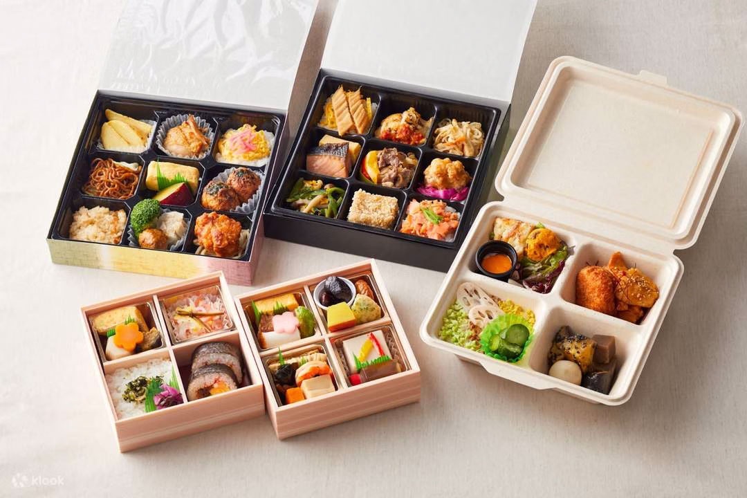 Assorted bento boxes at The Sumo Hall Hirakuza Osaka, featuring sushi, tempura, and traditional Japanese dishes.