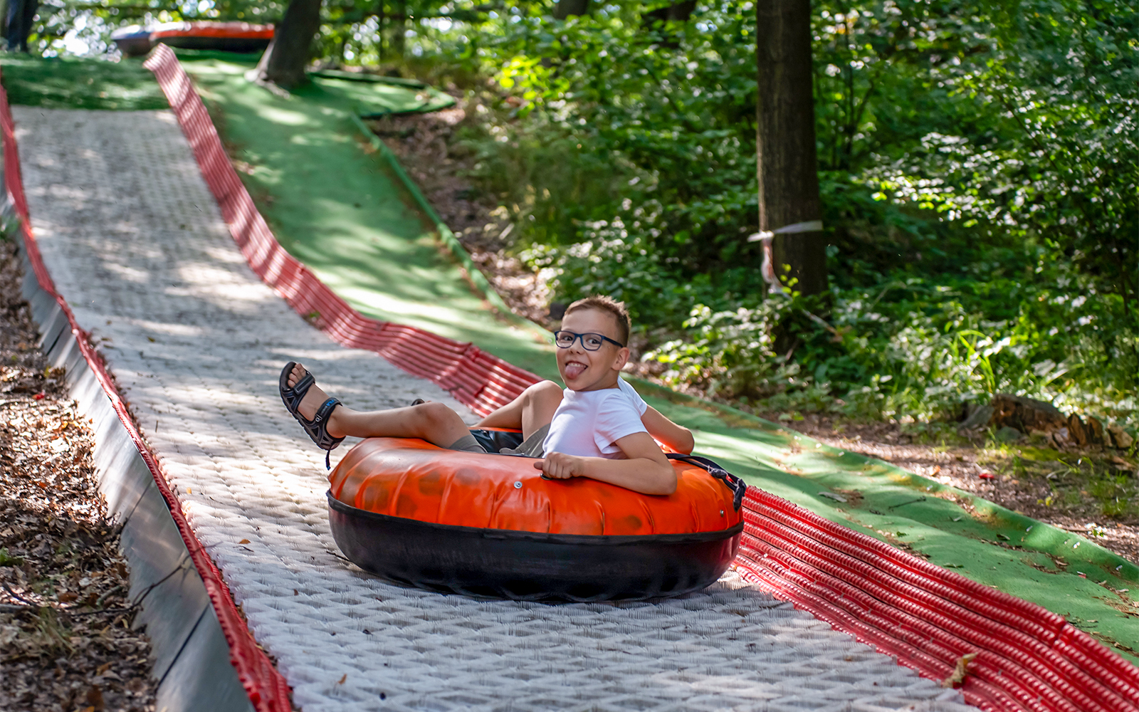 Tubby Racer ride at ESCAPE Penang theme park, Malaysia, featuring colorful inflatable tubes on a downhill track.
