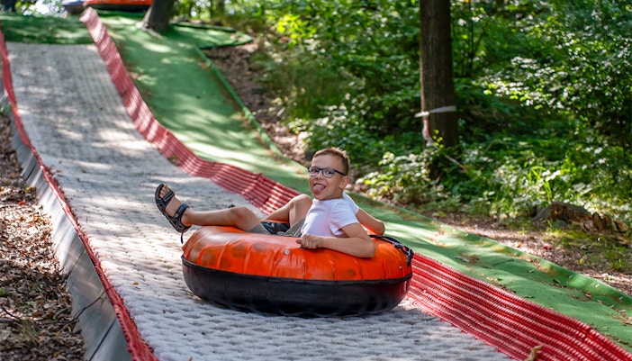 Tubby Racer ride at ESCAPE Penang theme park, Malaysia, featuring colorful inflatable tubes on a downhill track.