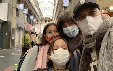 Family exploring Osaka market during self-guided food origins tour.