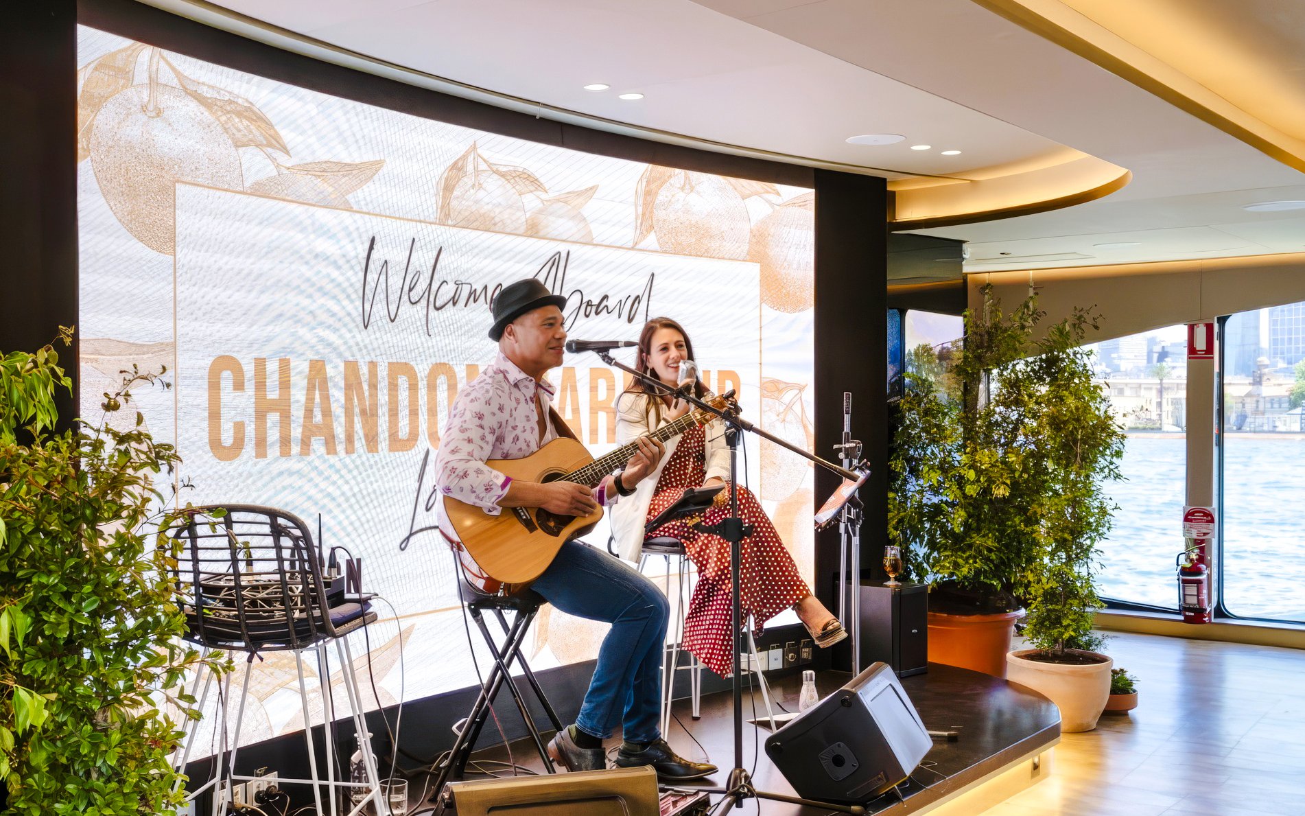 Musicians performing on The Jackson during Chandon Harbour Long Lunch with waterfront view.