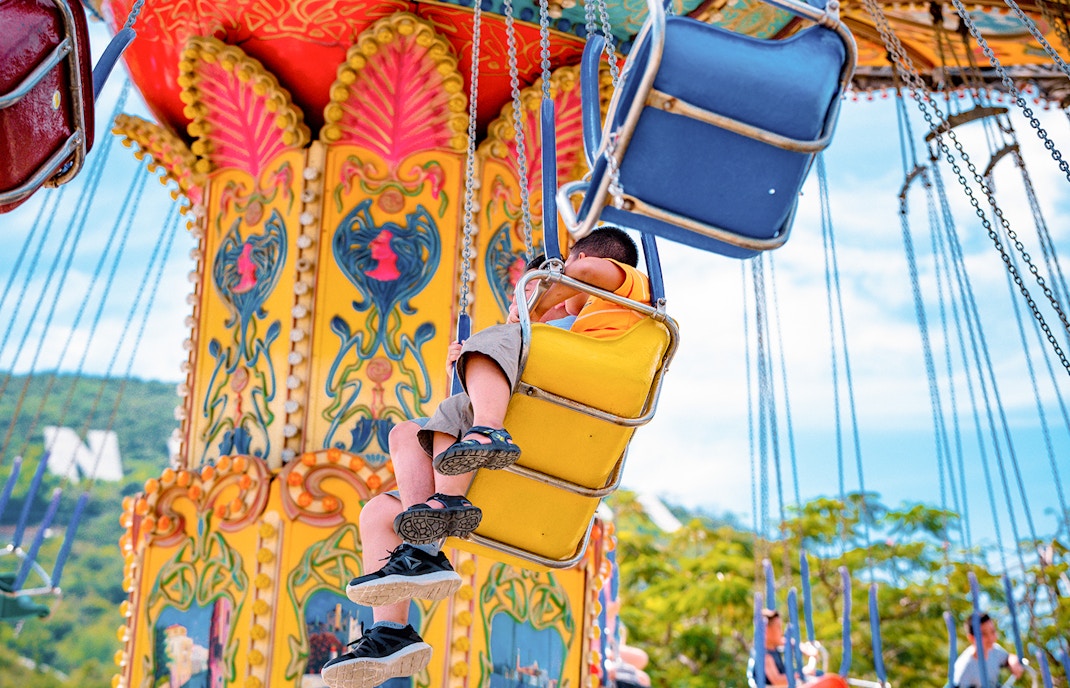 Visitors to the amusement park circling on the carousel in Sun Wheel and Asia Park