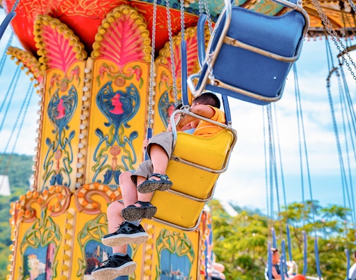 Visitors to the amusement park circling on the carousel in Sun Wheel and Asia Park