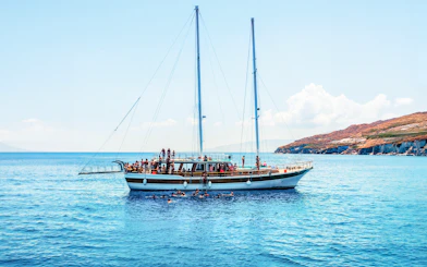 Sailing boat with tourists on an island hopping cruise near Athens, Greece.