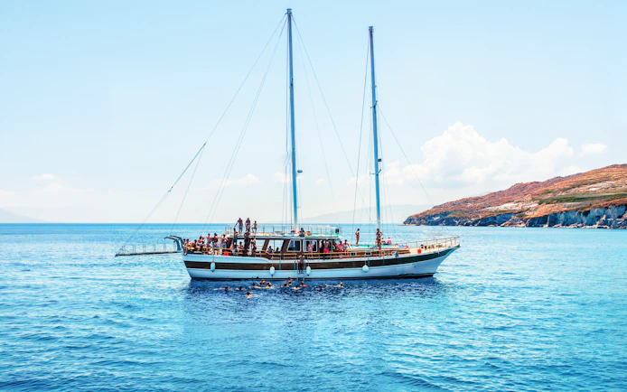 Sailing boat with tourists on an island hopping cruise near Athens, Greece.