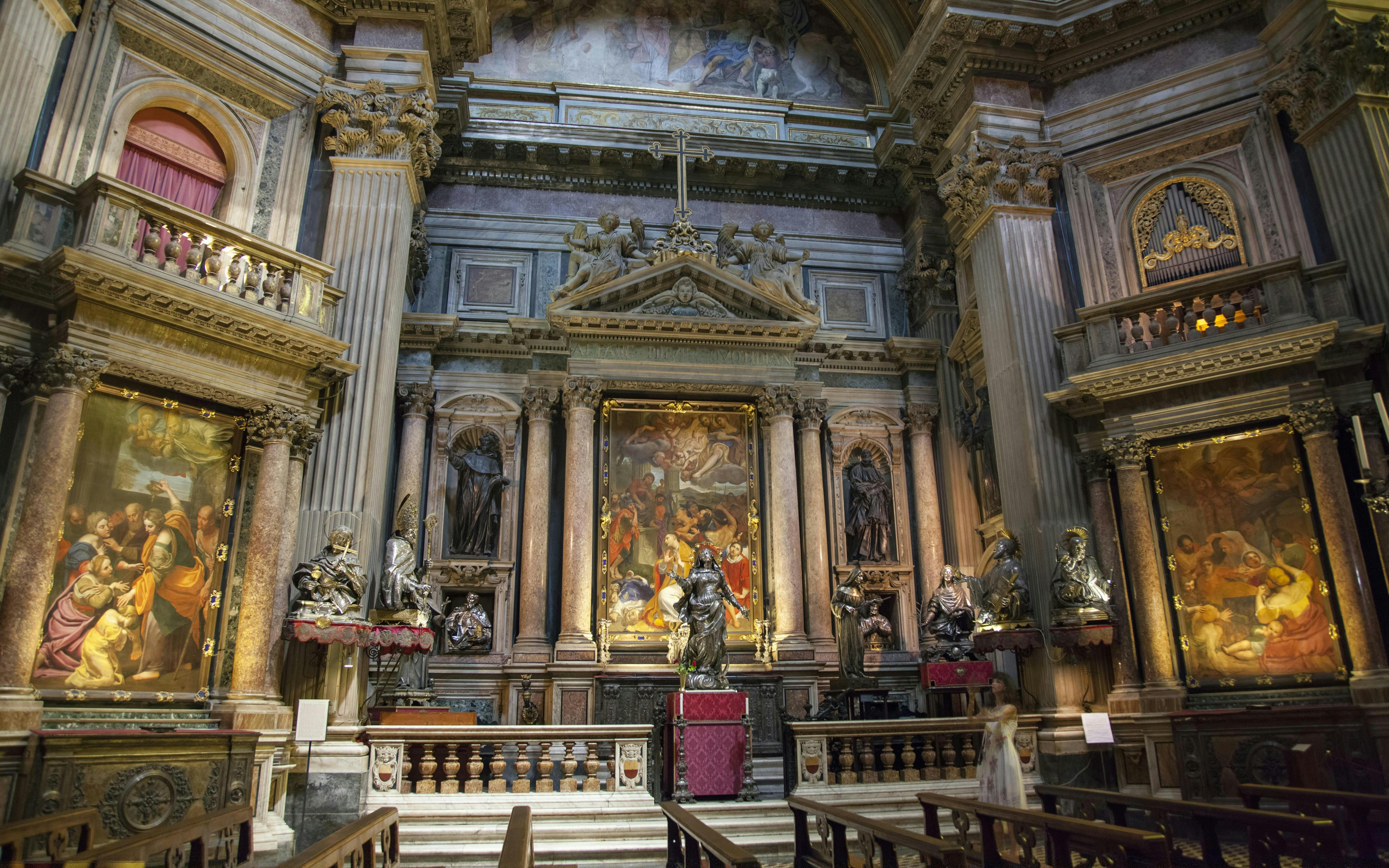 Royal Chapel of the Treasure of San Gennaro interior with ornate altar and religious paintings.