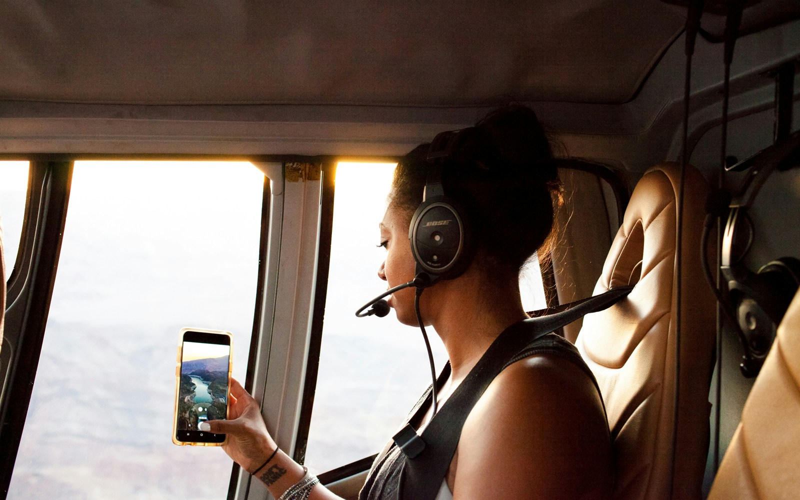 Guest viewing Grand Canyon South Rim from airplane window during 45-minute tour with optional Hummer excursion.