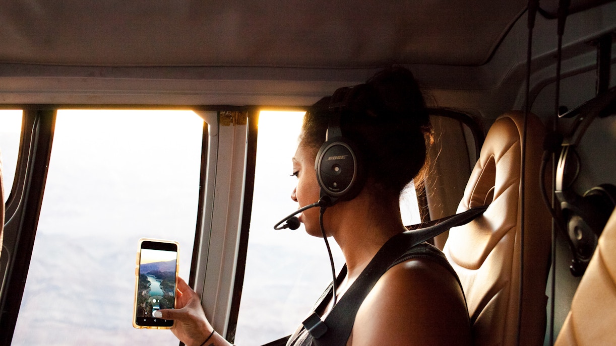 Guest viewing Grand Canyon South Rim from airplane window during 45-minute tour with optional Hummer excursion.