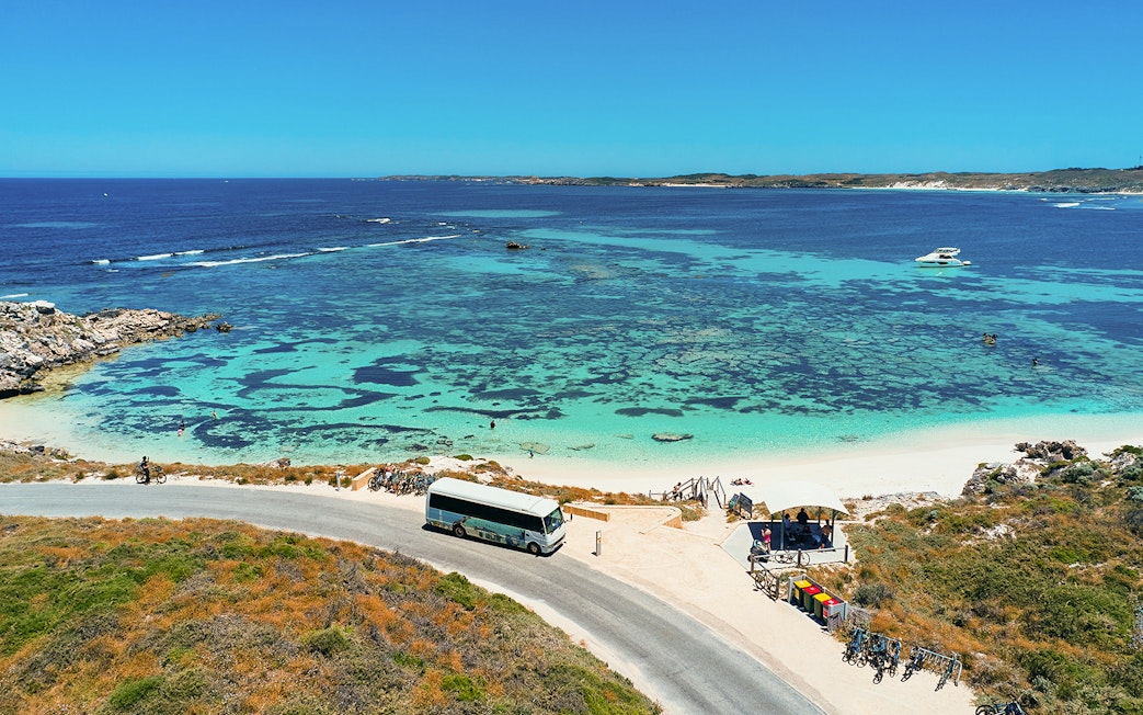 Tourists on a bus tour at Rottnest Island with coastline view, Perth or Fremantle return ferry.